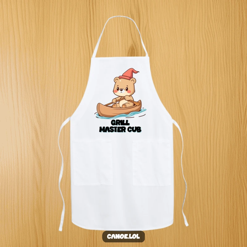 Funny Apron showing a cute bear cub steering a canoe with determination, ideal for kitchen adventures.