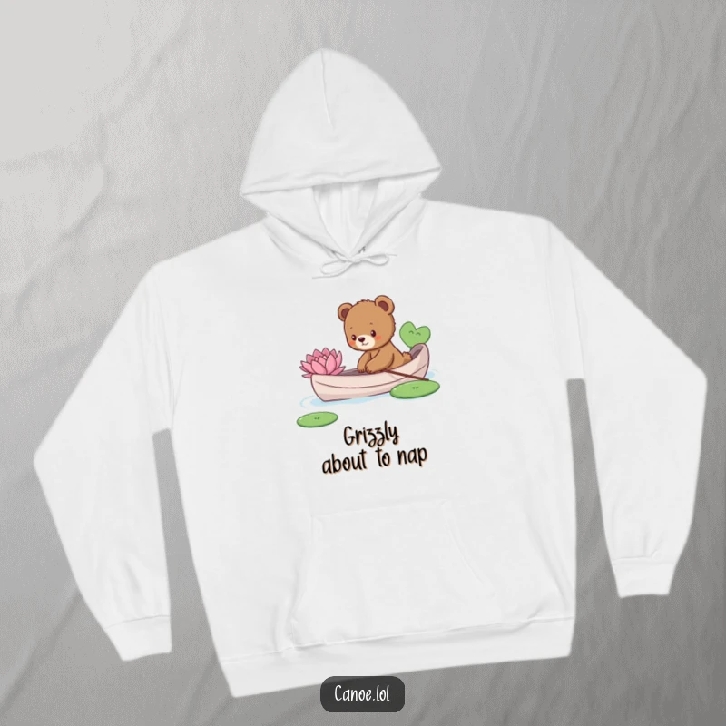 Funny curious bear cub reaching to touch a lily pad from a canoe, a cozy and humorous hoodie.
