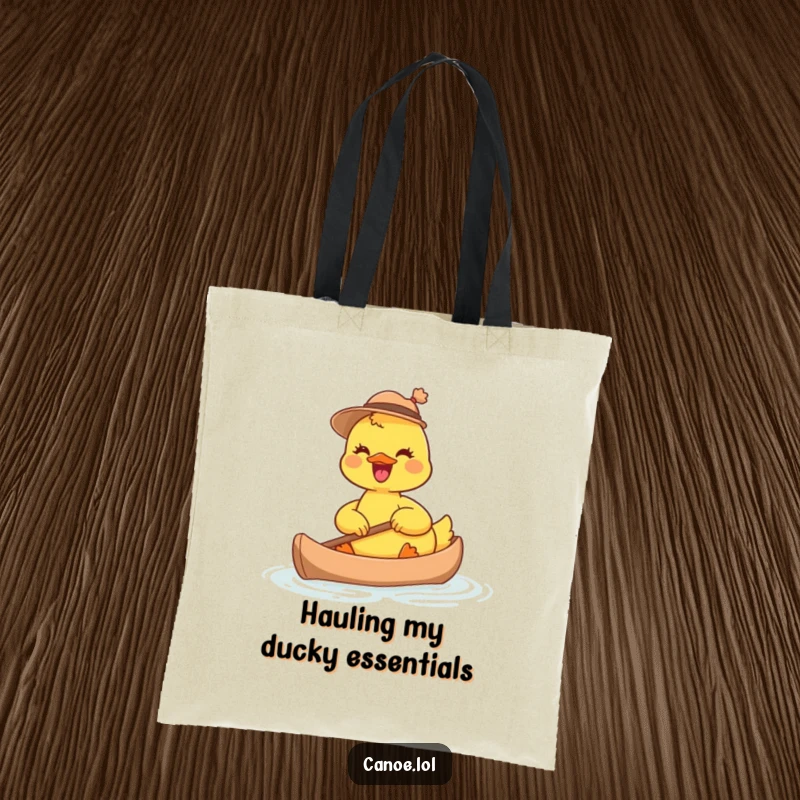 Funny joyful duckling in a small hat, paddling a tiny canoe, a whimsical and humorous tote bag.